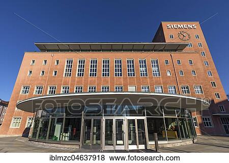 Main entrance with clock tower, office building of the Siemens company, also called raspberry palace, built in Berlin style 1948-1953, Erlangen, Middle Franconia, Bavaria, Germany, Europe View Large Photo Image Stock Photo - Main entrance with clock tower, office building of the Siemens company, also called raspberry palace, built in Berlin style 1948-1953, Erlangen, Middle Franconia, Bavaria, Germany, Europe. Fotosearch