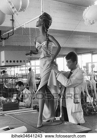 Stock Image - Man decorates mannequin, 1960s, Berlin, Germany, Europe. Fotosearch