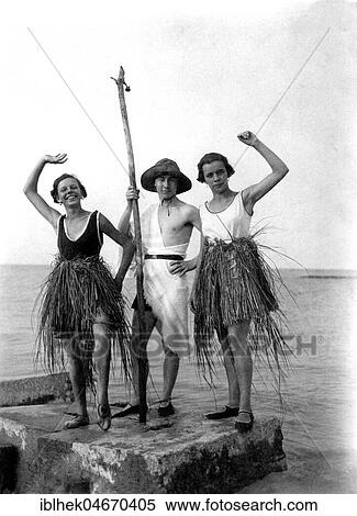 Stock Photography - Man dressed as Neptune, two women with bast skirt at the sea, 1920s, Germany, Europe. Fotosearch