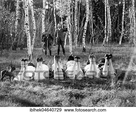 Stock Photo - Man is photographing six women in a beech forest, 1920s, exact place unknown, Germany, Europe. Fotosearch