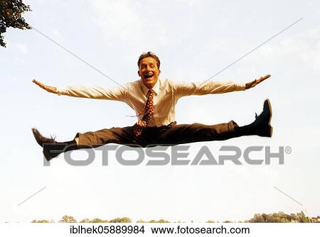 Man jumps in the air, businessman, joy, good mood, balancing act, Berlin, Germany, Europe View Large Photo Image Picture - Man jumps in the air, businessman, joy, good mood, balancing act, Berlin, Germany, Europe. Fotosearch