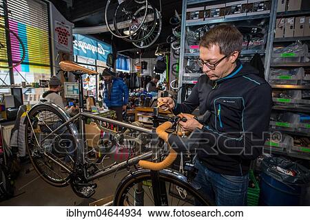 Man repairs bicycle, bike repair shop, Radcafe Schicke Mütze, Düsseldorf, North Rhine-Westphalia, Germany, Europe View Large Photo Image Picture - Man repairs bicycle, bike repair shop, Radcafe Schicke Mütze, Düsseldorf, North Rhine-Westphalia, Germany, Europe. Fotosearch
