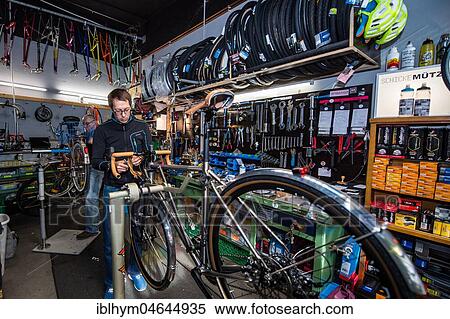 Man repairs bicycle, bike repair shop, Radcafe Schicke Mütze, Düsseldorf, North Rhine-Westphalia, Germany, Europe View Large Photo Image Stock Photography - Man repairs bicycle, bike repair shop, Radcafe Schicke Mütze, Düsseldorf, North Rhine-Westphalia, Germany, Europe. Fotosearch