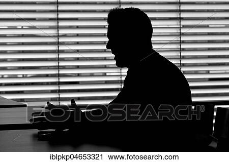 Man sitting at the table talking, silhouette View Large Photo Image Stock Image - Man sitting at the table talking, silhouette. Fotosearch