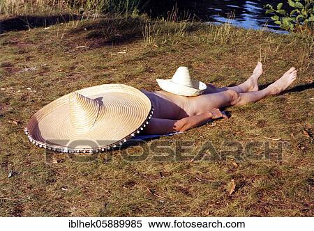 Stock Photography - Man sunning himself, Sombrero, Berlin, Germany, Europe. Fotosearch