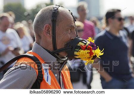 Man wearing bizarre face mask with flowers, demonstration against corona rules on the Rhine meadows, Düsseldorf, North Rhine-Westphalia, Germany, Europe View Large Photo Image Stock Image - Man wearing bizarre face mask with flowers, demonstration against corona rules on the Rhine meadows, Düsseldorf, North Rhine-Westphalia, Germany, Europe. Fotosearch