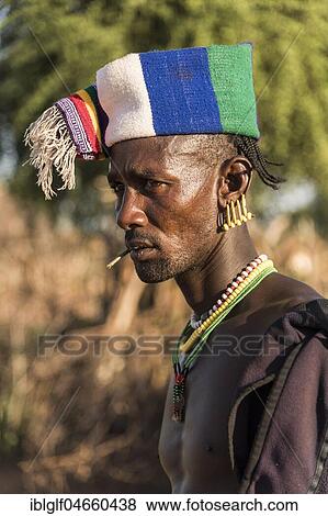 Man with colorful headgear, Hamer tribe, Turmi market, Southern Nations Nationalities and Peoples' Region, Ethiopia, Africa View Large Photo Image Stock Photo - Man with colorful headgear, Hamer tribe, Turmi market, Southern Nations Nationalities and Peoples' Region, Ethiopia, Africa. Fotosearch