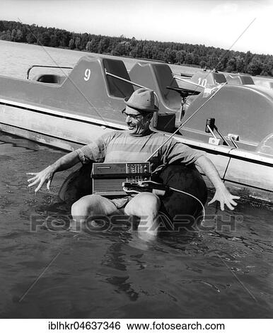 Stock Photograph - Man with radio in the water, ca. 1980s, exact place unknown, Germany, Europe. Fotosearch
