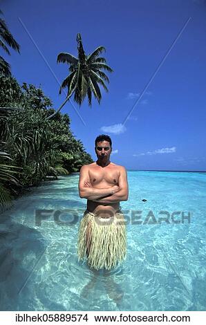 Picture - Man with raffia skirt in water, Maldives, Asia. Fotosearch