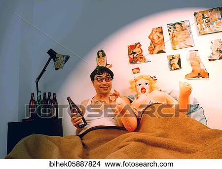 Picture - Man with sex doll in bed, Pinups, Berlin, Germany, Europe. Fotosearch