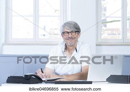 Man working at the laptop in the office View Large Photo Image Stock Photography - Man working at the laptop in the office. Fotosearch