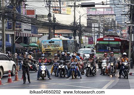 Many moped drivers are waiting at an intersection, traffic chaos in the Thanon Charoen Krung, Bang Rak, Bangkok, Thailand, Asia View Large Photo Image Stock Image - Many moped drivers are waiting at an intersection, traffic chaos in the Thanon Charoen Krung, Bang Rak, Bangkok, Thailand, Asia. Fotosearch