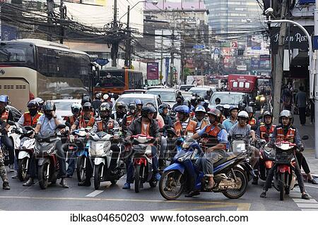 Many moped drivers are waiting at an intersection, traffic chaos in the Thanon Charoen Krung, Bang Rak, Bangkok, Thailand, Asia View Large Photo Image Stock Image - Many moped drivers are waiting at an intersection, traffic chaos in the Thanon Charoen Krung, Bang Rak, Bangkok, Thailand, Asia. Fotosearch