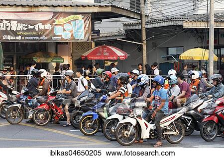 Many moped drivers are waiting at an intersection, morning traffic in the Thanon Charoen Krung, Bang Rak, Bangkok, Thailand, Asia View Large Photo Image Stock Photography - Many moped drivers are waiting at an intersection, morning traffic in the Thanon Charoen Krung, Bang Rak, Bangkok, Thailand, Asia. Fotosearch