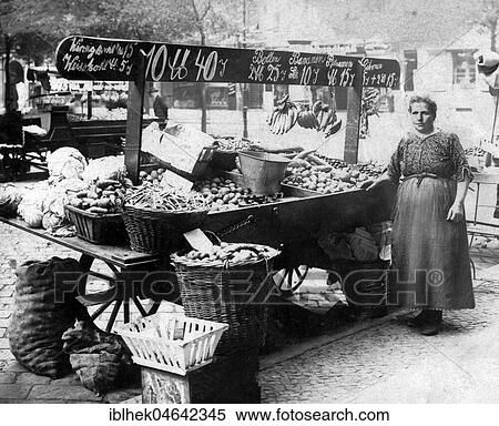 Stock Photography - Market woman sells vegetables at market stall, 1920s, Germany, Europe. Fotosearch