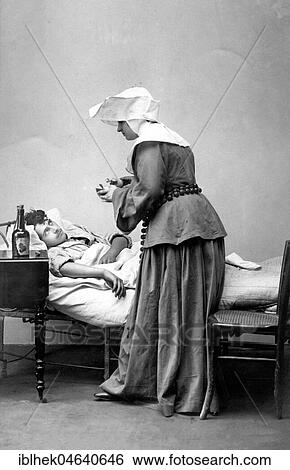 Stock Photograph - Medicine, health, nurse takes care of a patient, ca. 1900s, exact location unknown, France, Europe. Fotosearch