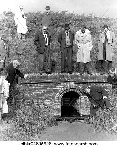 Stock Photograph - Men looking for something in a creek, 1950s, exact place unknown, Germany, Europe. Fotosearch