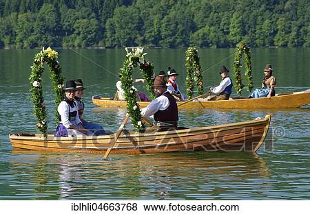 Men wearing traditional costumes in festively decorated squares, wooden boats, on the Schliersee lake, Alt-Schlierseer-Kirchtag, Schliersee, Upper Bavaria, Bavaria, Germany, Europe View Large Photo Image Stock Photo - Men wearing traditional costumes in festively decorated squares, wooden boats, on the Schliersee lake, Alt-Schlierseer-Kirchtag, Schliersee, Upper Bavaria, Bavaria, Germany, Europe. Fotosearch