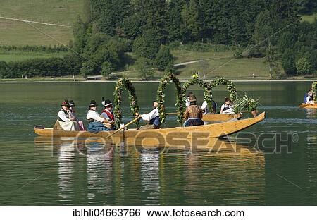 Men wearing traditional costumes in festively decorated squares, wooden boats, on the Schliersee lake, Alt-Schlierseer-Kirchtag, Schliersee, Upper Bavaria, Bavaria, Germany, Europe View Large Photo Image Stock Photograph - Men wearing traditional costumes in festively decorated squares, wooden boats, on the Schliersee lake, Alt-Schlierseer-Kirchtag, Schliersee, Upper Bavaria, Bavaria, Germany, Europe. Fotosearch