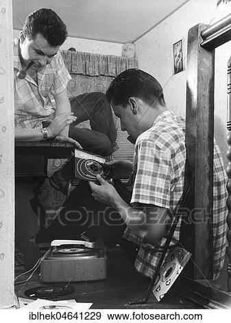 Stock Photo - Men with pipe and old turntable, 1960s, Berlin, Germany, Europe. Fotosearch