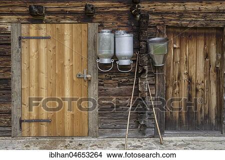 Milk pots hanging on stable wall, mountain village Oberstalleralm, Innervillgraten, Tyrol, Austria, Europe View Large Photo Image Picture - Milk pots hanging on stable wall, mountain village Oberstalleralm, Innervillgraten, Tyrol, Austria, Europe. Fotosearch