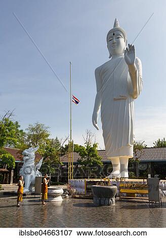 Monks in front of a gigantic Buddha statue in Wat Pa Thamma Utthayan, Khon Kaen, Isan, Thailand, Asia View Large Photo Image Stock Photo - Monks in front of a gigantic Buddha statue in Wat Pa Thamma Utthayan, Khon Kaen, Isan, Thailand, Asia. Fotosearch