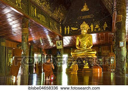 Monks in front of golden Buddha statue, Wat Phuttha Nimit Phra Saiyat, Phra Buddha Phukhao, Sahatsakhan District, Kalasin, Isan, Thailand, Asia View Large Photo Image Stock Photograph - Monks in front of golden Buddha statue, Wat Phuttha Nimit Phra Saiyat, Phra Buddha Phukhao, Sahatsakhan District, Kalasin, Isan, Thailand, Asia. Fotosearch