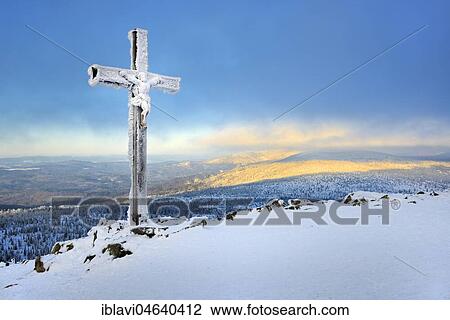 Stock Image - Morning atmosphere on the Lusen mountain in winter, icy summit cross, Bavarian Forest National Park, Bavaria, Germany, Europe. Fotosearch