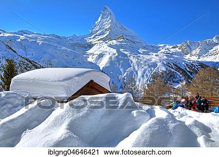 Stock Image - Mountain hut with deep snowfall on Riffelalp 2222m in front of Matterhorn 4478m, Zermatt, Mattertal, Valais, Switzerland, Europe. Fotosearch