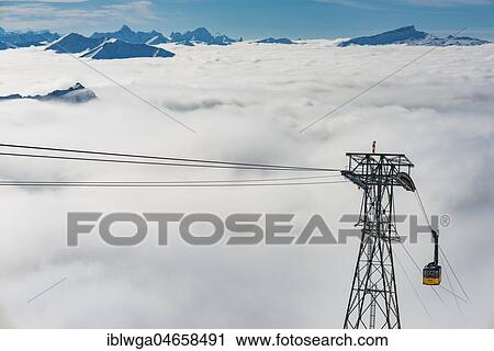 Stock Image - Mountain peaks protrude from clouds, cable car to station Höfatsblick, Nebelhorn, 2224m, near Oberstdorf, Allgäu Alps, Allgäu, Bavaria, Germany, Europe. Fotosearch