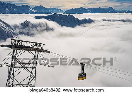 Stock Image - Mountain peaks protrude from clouds, cable car to station Höfatsblick, Nebelhorn, 2224m, near Oberstdorf, Allgäu Alps, Allgäu, Bavaria, Germany, Europe. Fotosearch