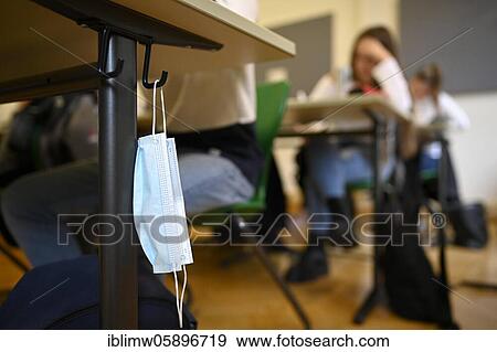 Stock Photo - Mouth mask hangs on student's desk, classroom teaching, Corona crisis, Stuttgart, Baden-Württemberg, Germany, Europe. Fotosearch