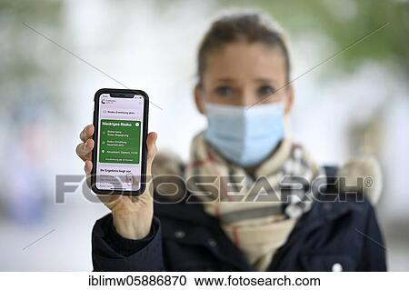 Negative test result, woman with face mask, showing smartphone with Corona Warn-APP, Corona crisis, Stuttgart, Baden-Württemberg, Germany, Europe View Large Photo Image Stock Image - Negative test result, woman with face mask, showing smartphone with Corona Warn-APP, Corona crisis, Stuttgart, Baden-Württemberg, Germany, Europe. Fotosearch