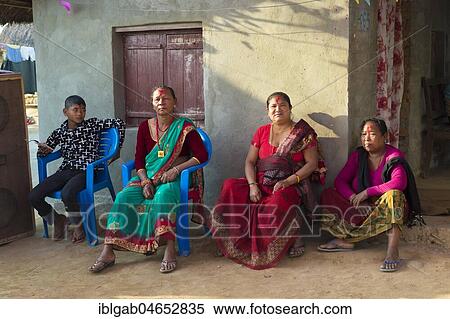 Nepalese women from the Tharu ethnic group sitting in front of a house during a wedding, Chitwan, Nepal, Asia View Large Photo Image Stock Photography - Nepalese women from the Tharu ethnic group sitting in front of a house during a wedding, Chitwan, Nepal, Asia. Fotosearch
