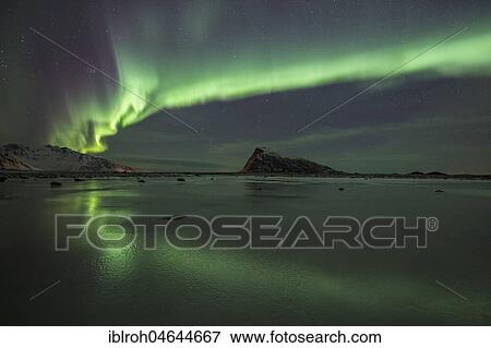 Stock Photo - Northern Lights, Aurora Borealis, over frozen lake, Haukland, Lofoten, Norway, Europe. Fotosearch