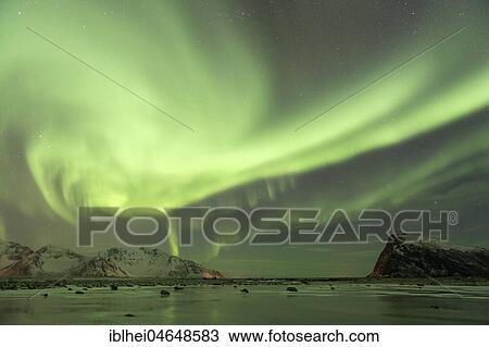 Stock Image - Northern lights on the coast near Gimsoy, Lofoten, Norway, Europe. Fotosearch