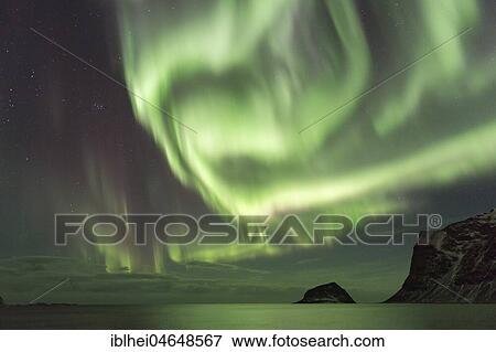 Stock Photo - Northern lights on the coast near Gimsoy, Lofoten, Norway, Europe. Fotosearch