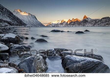Norwegian fjord, snow-covered mountains at sunset, near Mefjordvær, Senja Island, Norway, Europe View Large Photo Image Stock Photography - Norwegian fjord, snow-covered mountains at sunset, near Mefjordvær, Senja Island, Norway, Europe. Fotosearch