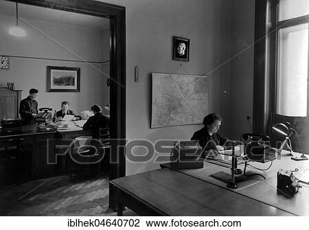 Stock Image - Office, men and women at the desk, 1940s, exact location unknown, Germany, Europe. Fotosearch