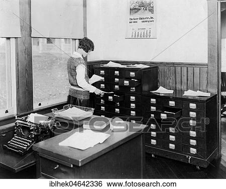 Stock Photograph - Office, secretary, woman doing office work, 1920s, USA, North America. Fotosearch