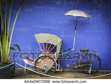 Old bicycle rickshaw, rickshaw on the blue wall, Cheong Fatt Tze Mansion, blue villa, Leith Street in George Town, Penang, Malaysia, Asia View Large Photo Image Stock Photo - Old bicycle rickshaw, rickshaw on the blue wall, Cheong Fatt Tze Mansion, blue villa, Leith Street in George Town, Penang, Malaysia, Asia. Fotosearch