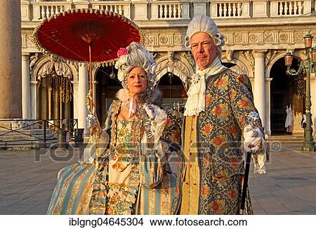 Pair in historical robes, rococo costume, on the Piazzetta, Carnival in Venice, Italy, Europe View Large Photo Image Picture - Pair in historical robes, rococo costume, on the Piazzetta, Carnival in Venice, Italy, Europe. Fotosearch