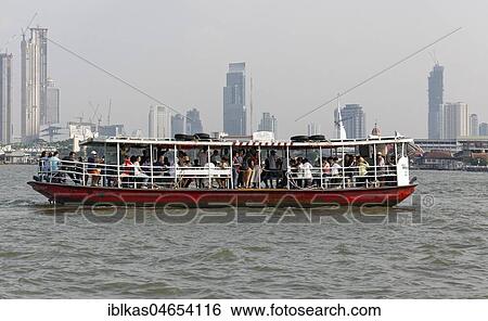Passenger ferry crosses the river Mae Nam Chao Phraya, skyline financial district Bang Rak, Bangkok, Thailand, Asia View Large Photo Image Stock Photograph - Passenger ferry crosses the river Mae Nam Chao Phraya, skyline financial district Bang Rak, Bangkok, Thailand, Asia. Fotosearch