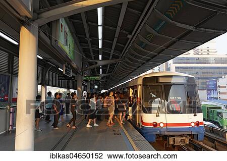 People board the BTS Skytrain in the morning, Saphan Taksin Station, Sathon, Bangkok, Thailand, Asia View Large Photo Image Stock Image - People board the BTS Skytrain in the morning, Saphan Taksin Station, Sathon, Bangkok, Thailand, Asia. Fotosearch