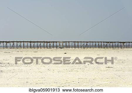 Stock Image - Pipeline on stilts on the Assale Salt Lake for the transport of brine to the evaporation basins of a salt works, commercial salt production near Hamadela, Danakil Depression, Afar Region, Ethiopia, Africa. Fotosearch