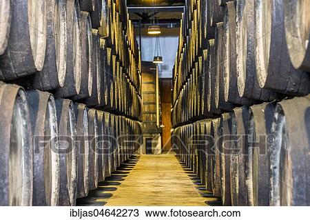 Stock Image - Plenty of port wine barrels in a wine cellar in Vila Nova de Gaia, Portugal, Europe. Fotosearch