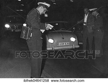 Stock Photo - Police officers during a traffic check, 1960s, Berlin, Germany, Europe. Fotosearch