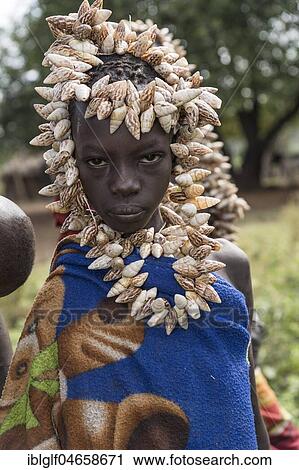 Stock Image - Portrait, woman with headdress made of shells from the Mursi tribe, Southern Nations Nationalities and Peoples' Region, Ethiopia, Africa. Fotosearch