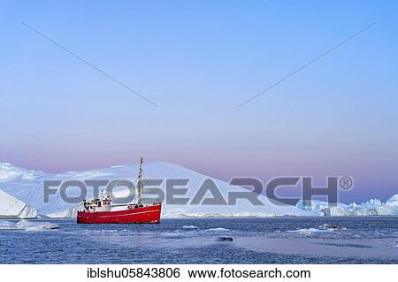 Stock Photograph - Red boat with tourists in front of icebergs at the blue hour, Icefjord, UNESCO World Natural Heritage, Disko Bay, Ilulissat, West Greenland, Greenland, North America. Fotosearch