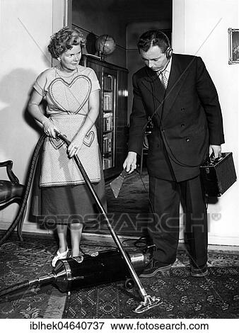 Stock Photo - Representative and housewife with vacuum cleaner, man measuring the noise, 1950s, exact location unknown, Germany, Europe. Fotosearch